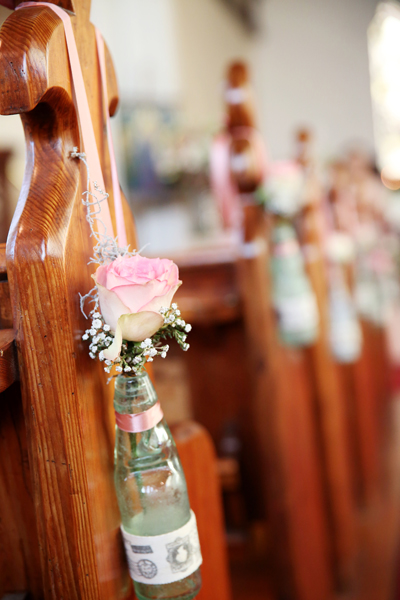 Glass bottle and floral arrangment down isle